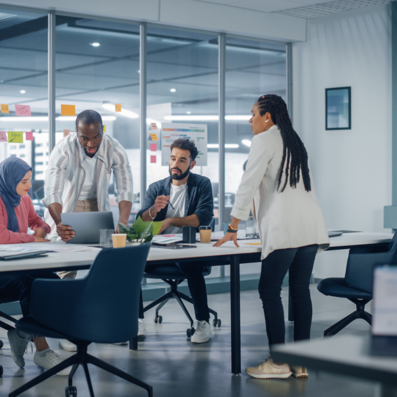 An image of four people having a business meeting at a table in an office