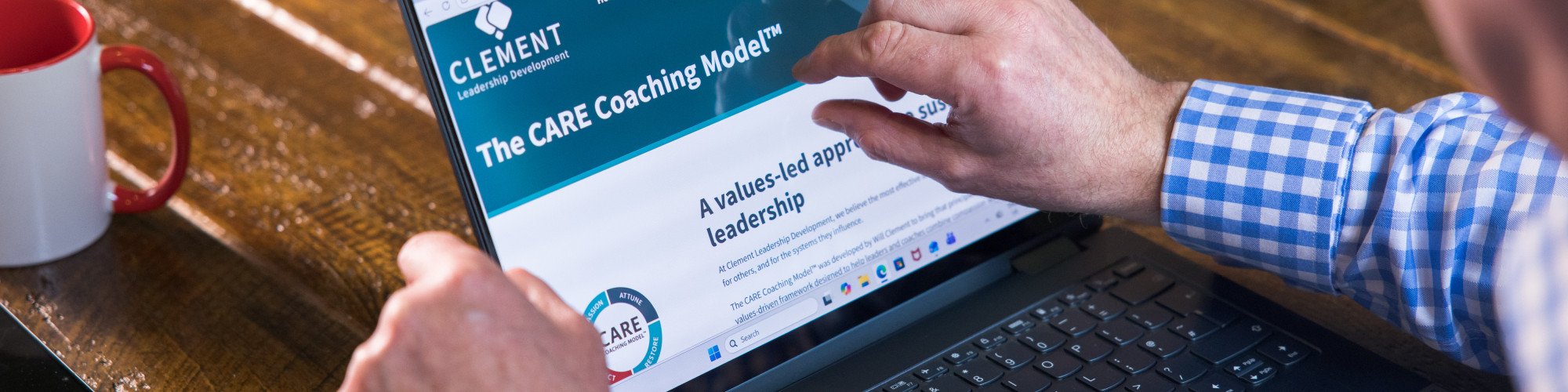 Consultant reviewing the CARE Coaching Model™ during a leadership development discussion.